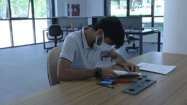A medical student studies in the library where he was a worker in construction once