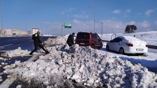 Kar yağışında yol ortasında bıraktıkları araçlarını kazma kürekle kurtardılar