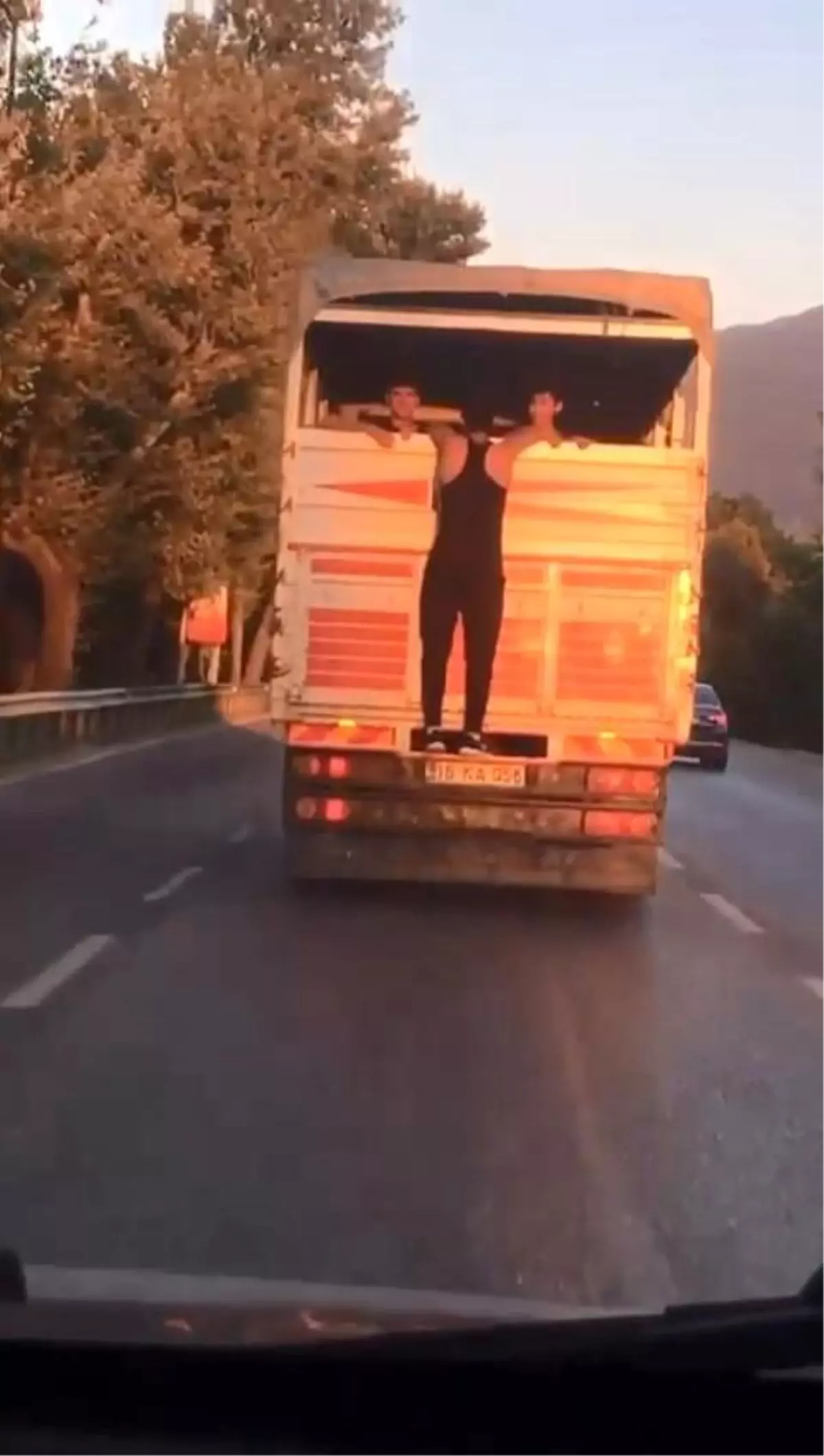 Kamyon kasasının kapağına tutunarak gitti, görenlerin yüreğini ağzına getirdi