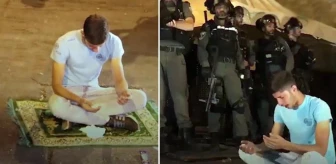 Filistinli genç, polis barikatlarının arasında seccadesine oturup bağırarak yalvardı: Allah'ım yardım et