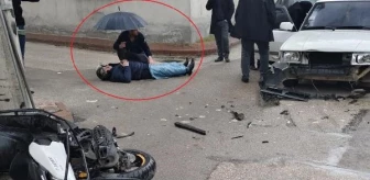 İnegöl'de motosikletli otomobil kazasında yaralanan kişiye şemsiyeyle destek