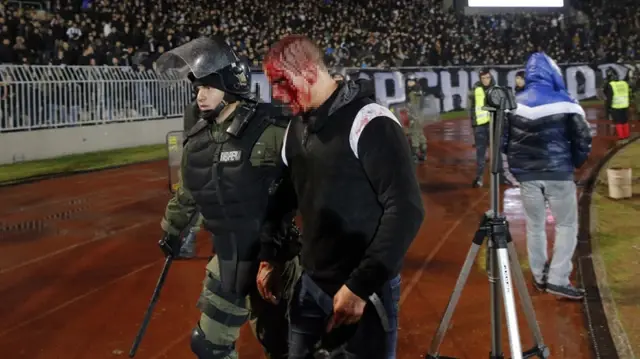 The partisan fans stormed the locker room after the match and beat up the head coach.