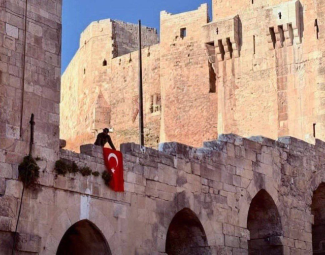 DEM Party's Gülistan Kılıç Koçyiğit is disturbed by the raising of the Turkish flag at Aleppo Castle