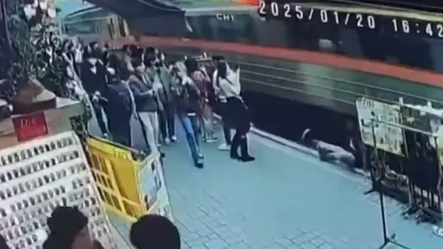 She touched the train while posing and fell onto the tracks