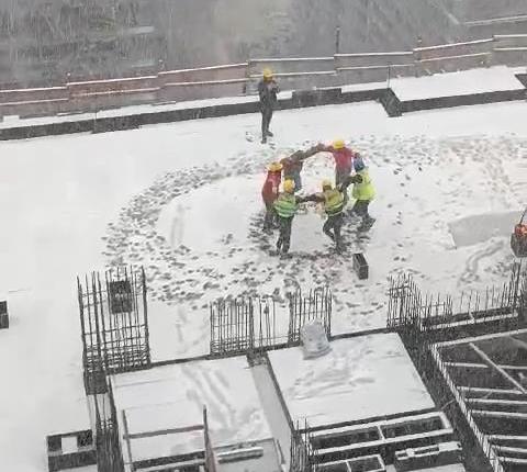 Construction workers danced horon under the snow