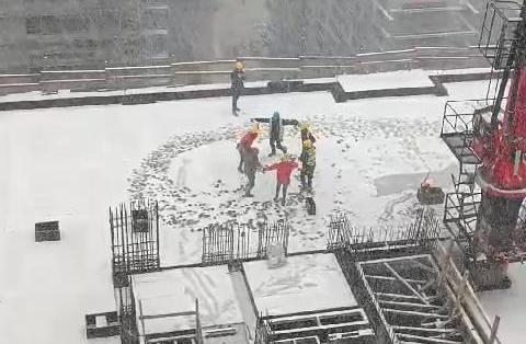 Construction workers danced horon under the snow