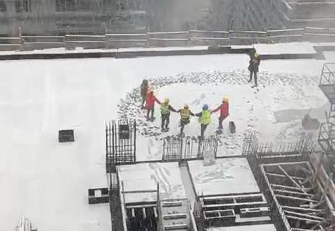 Construction workers danced horon under the snow