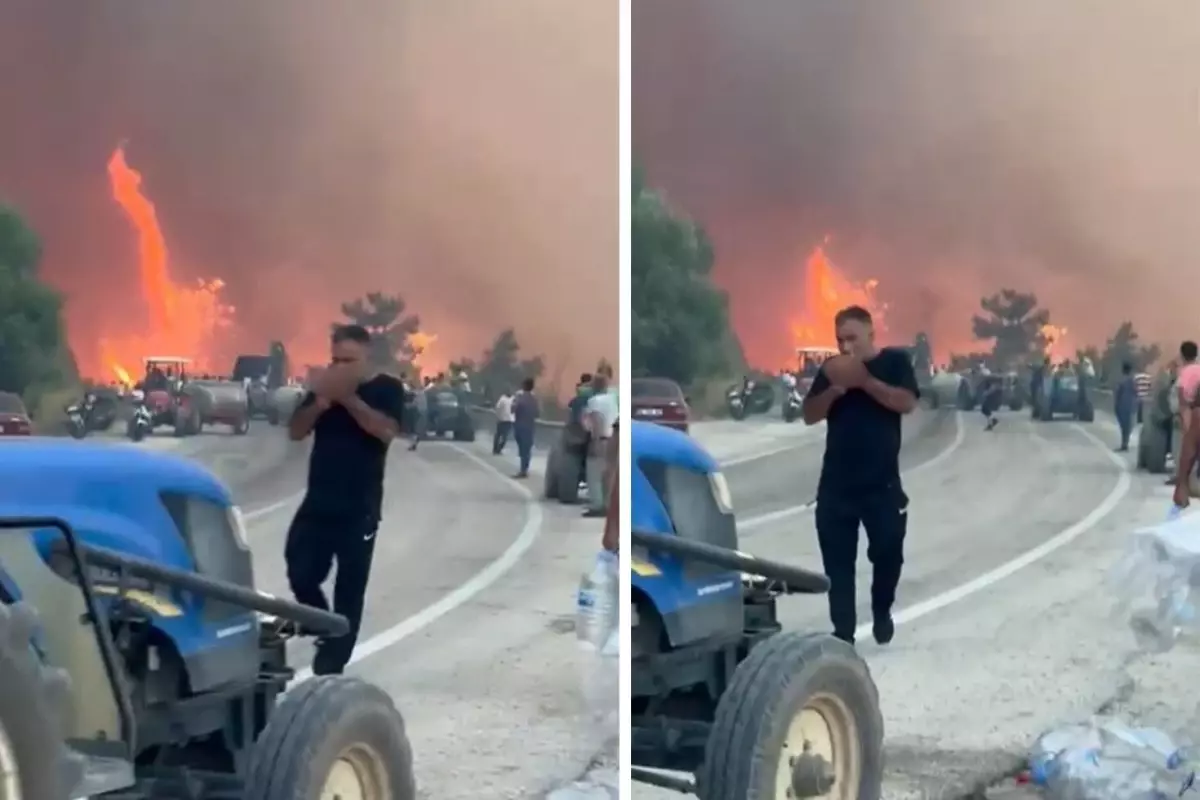 Alevlerin ortasında tepki çeken görüntüler! Orman kül olurken, o sigara yaktı