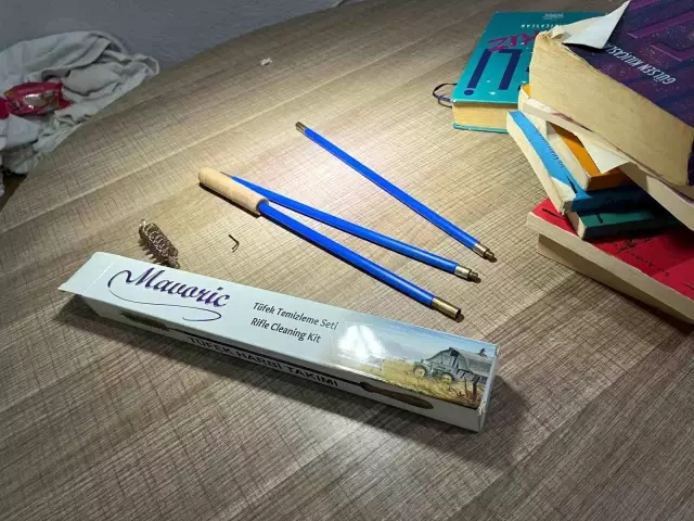 Notable detail in the assailant's room: Gun cleaning kits and books