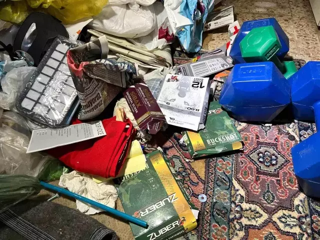 Notable detail in the assailant's room: Gun cleaning kits and books