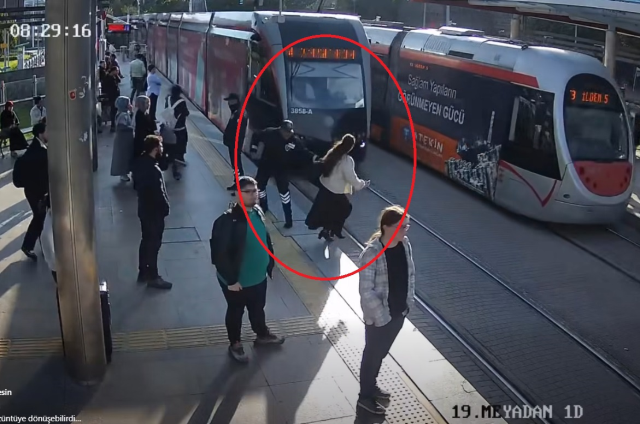 The security officer saved her from being under the tram; those moments were captured on camera
