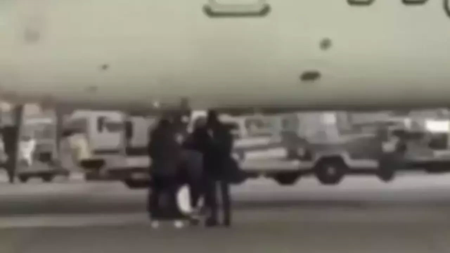 The two passengers who missed their flight broke the glass of the emergency exit door and jumped onto the runway