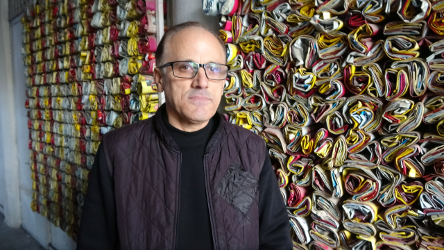 'He has been collecting for 18 years so that customers know what they are drinking! He displays thousands of them in his shop'