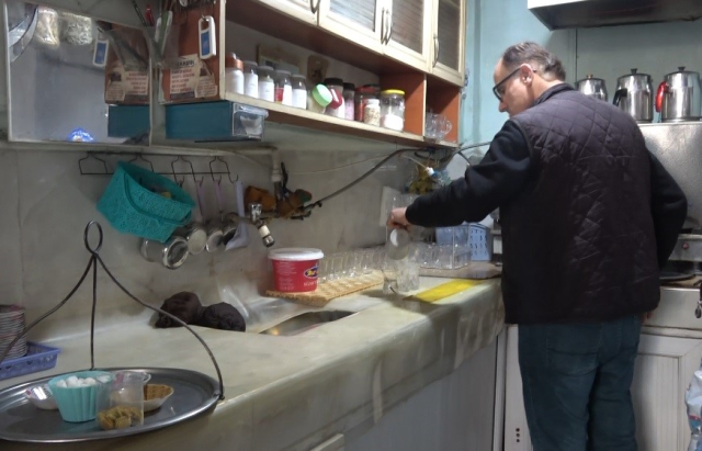 'He has been collecting for 18 years so that customers know what they are drinking! He displays thousands of them in his shop'