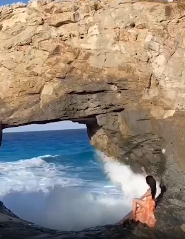She was risking her life for a photo: The giant wave swept the tourist into the sea