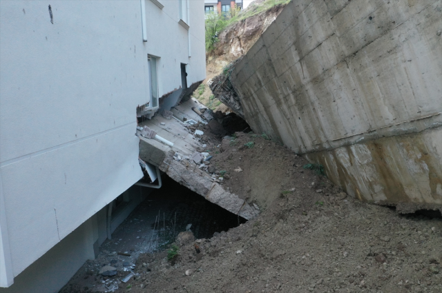 Collapsed retaining wall caused damage