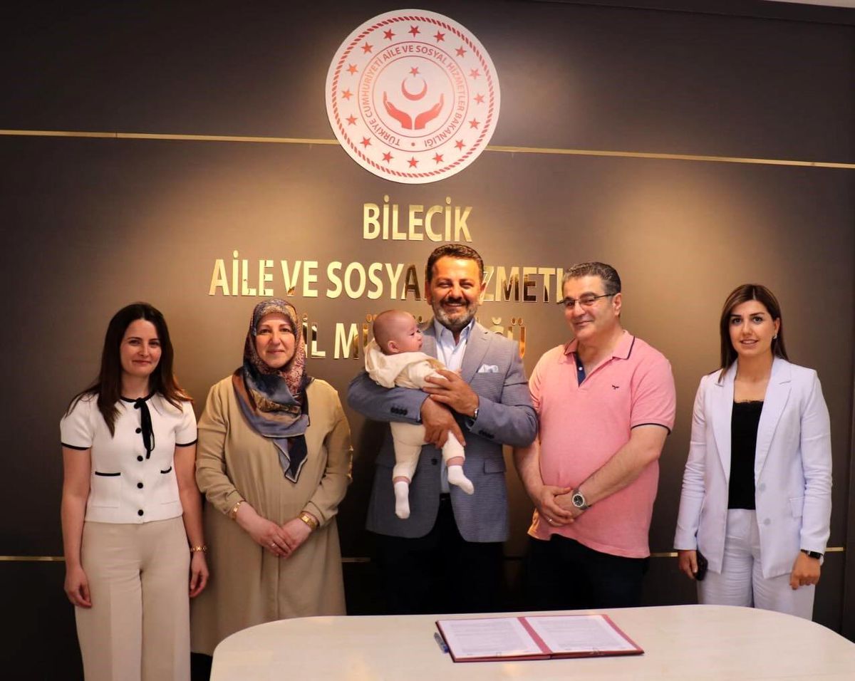 Bilecik Aile ve Sosyal Hizmetler İl Müdürlüğü'nde koruyucu aile sözleşmesi imzalayan yetkililer ve aile üyeleri