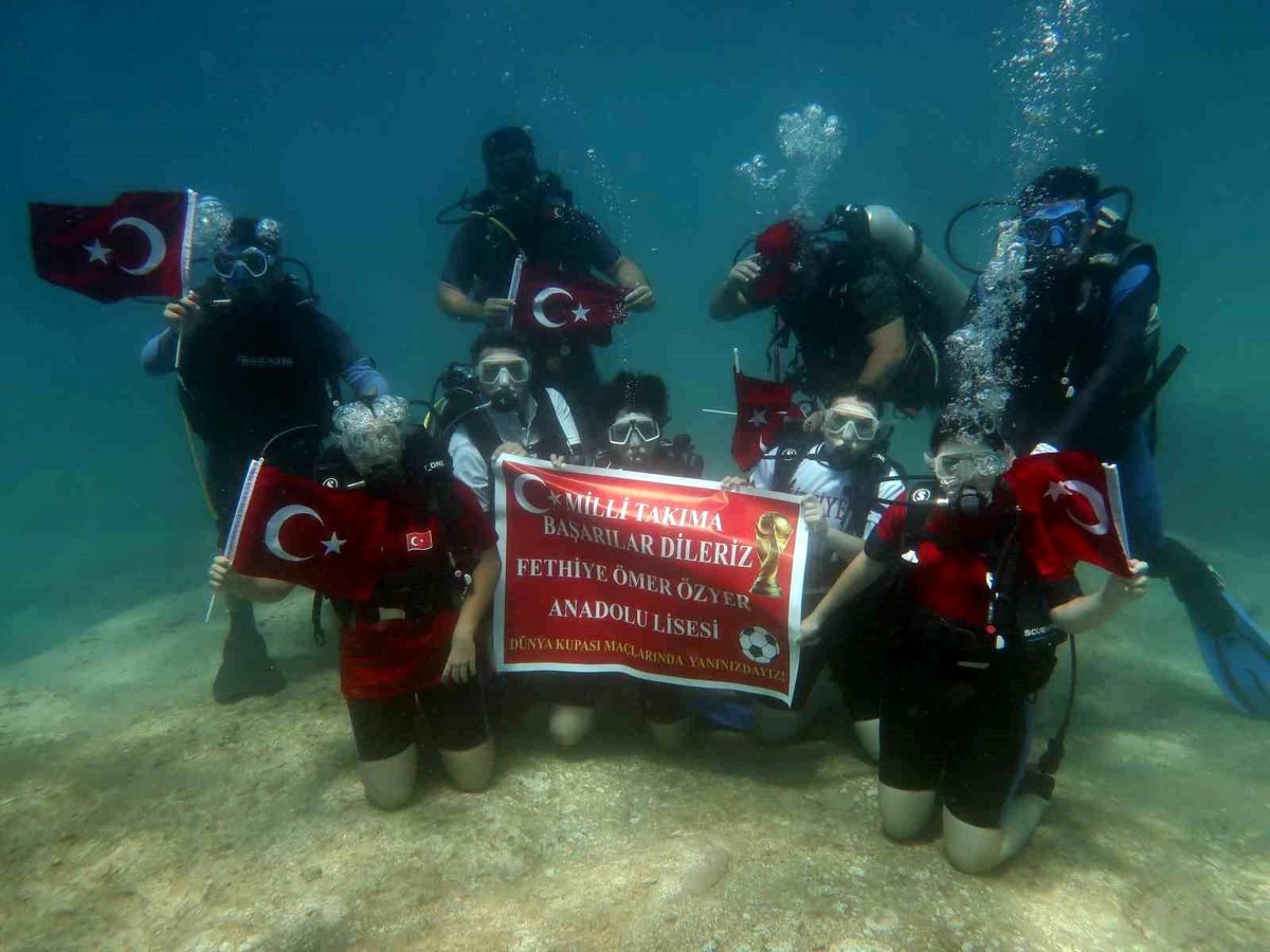 Fethiye'deki öğrenciler su altında Milli Takım için pankart açıyor.