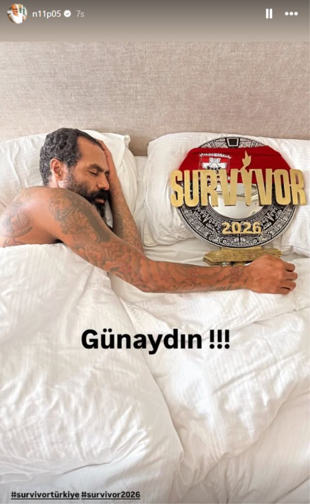 Mert Nobre sleeping with Survivor championship cup