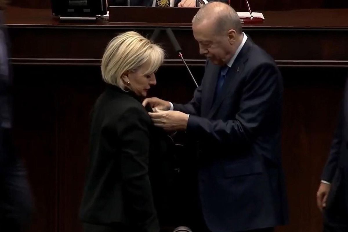 Nimet Özdemir AK Parti rozeti takarken.