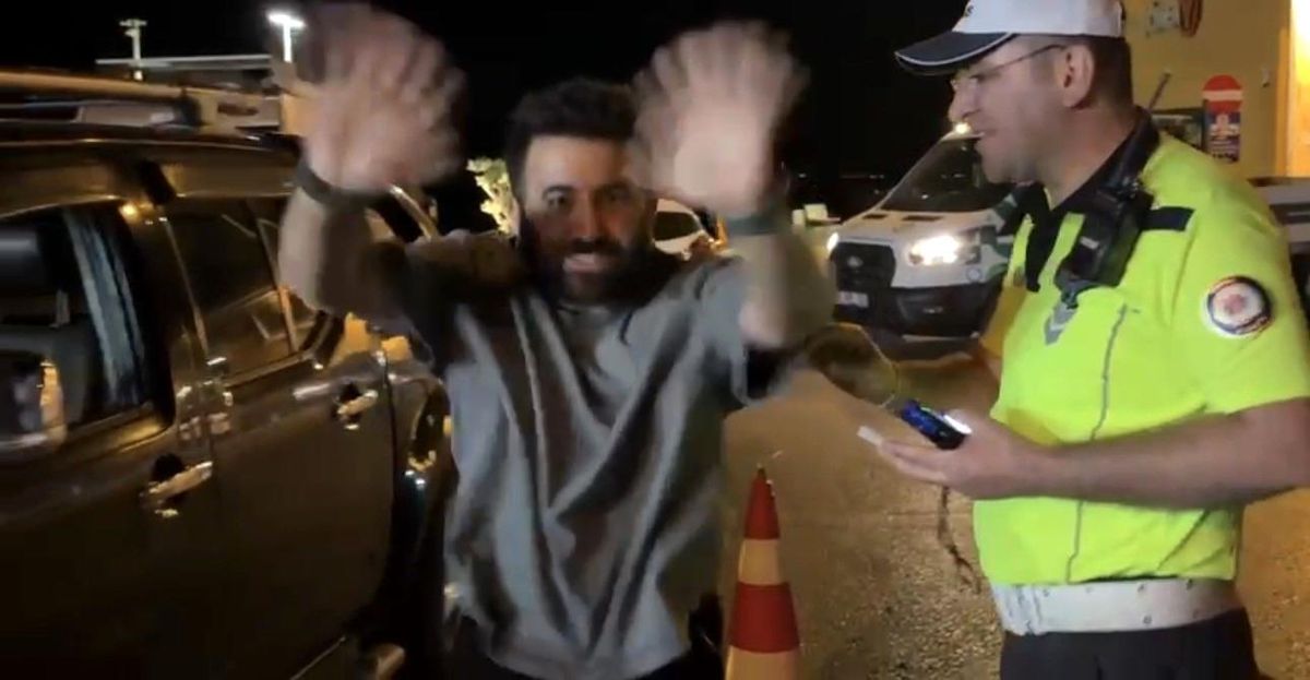 Mudanya'da trafik polislerinin alkol denetiminde alkolsüz çıkan bir sürücü kameralara el sallayarak sevincini gösteriyor.