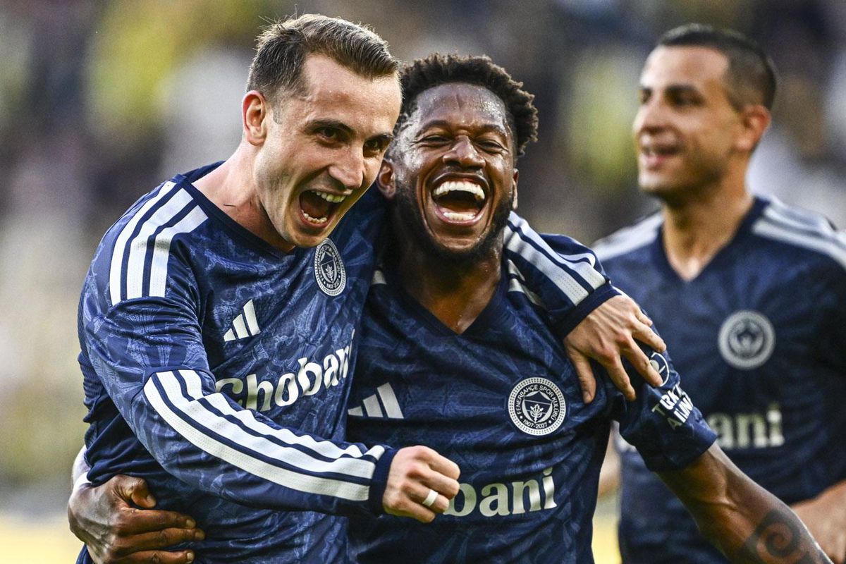 Fenerbahçe futbol takımı oyuncuları sahada galibiyeti kutluyor.