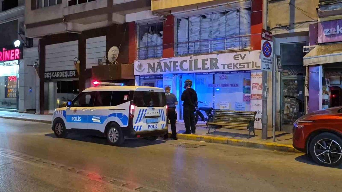 Eskişehir'de bir iş yerinin kırık camı ve olay yerine gelen polis ekipleri.