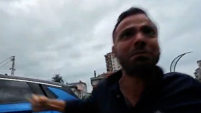 Passerby trying to cover the camera