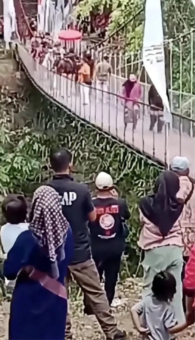 The newly completed bridge collapsed sideways as its cable snapped during the opening ceremony