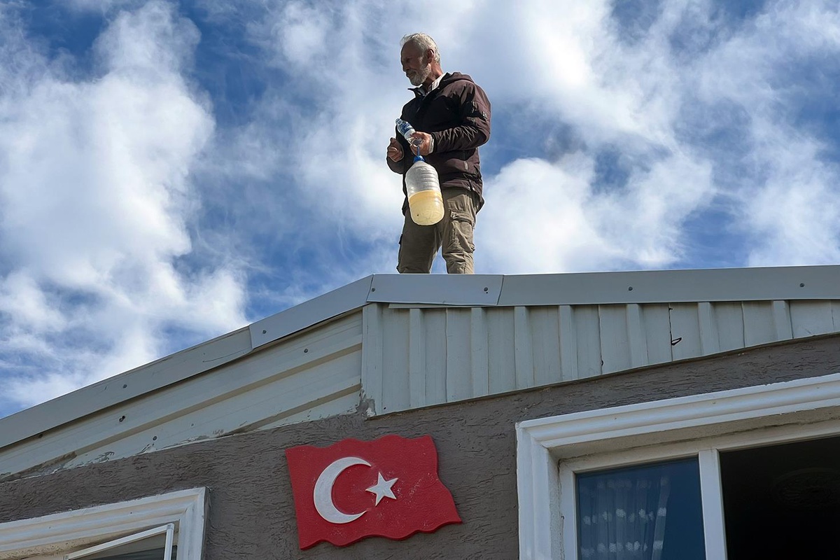 Kaçak evinin yıkımına engel olmak için benzin bidonuyla çatıya çıktı