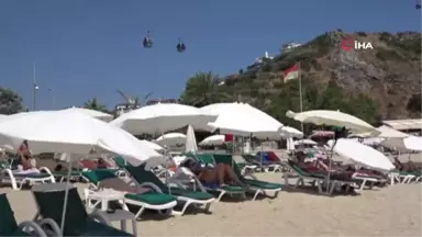 Alanya'da aşırı sıcaktan bunalan tatilciler sahile akın etti